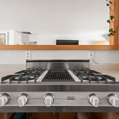 Fully equipped kitchen with a stainless steel stove.