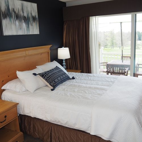 Guest bedroom:  features a queen-size bed, private entrance from the deck, nightstands with lamps, a dresser, closet, chair, and its own television.