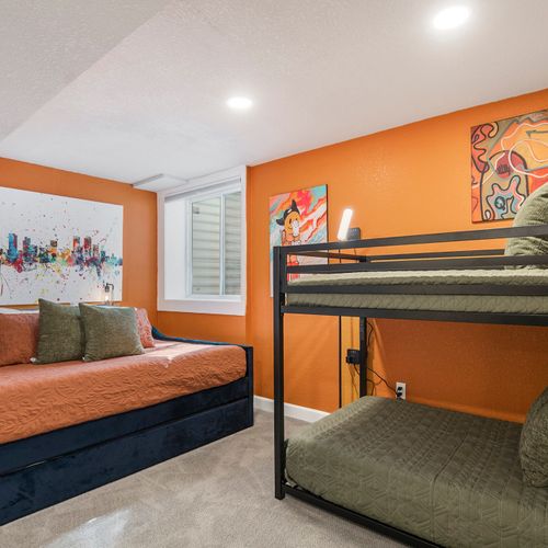 Brighten up your stay in the colorful fifth bedroom downstairs, featuring twin bunk beds and a cozy daybed, perfect for kids or extra guests!