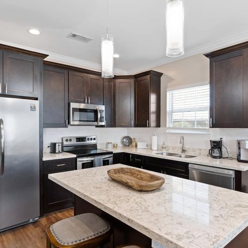 Kitchen island w/ bar stools — a casual spot to enjoy meals or morning coffee.