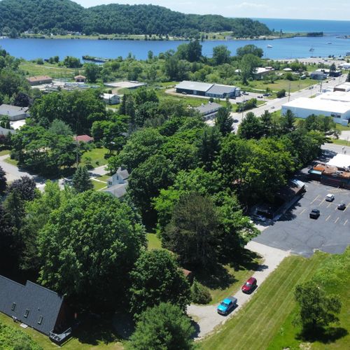 Overall:  aerial view showing the chalet in the lower left with betsie lake at the top, downtown frankfort at the right, and lake michigan in the distance