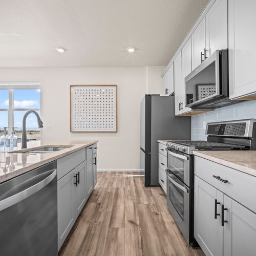 Fully equipped kitchen with stainless steel appliances and a clean, open layout.