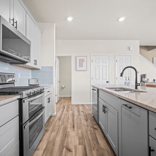 Open-concept kitchen with elegant island seating, blending style and comfort for everyday living.