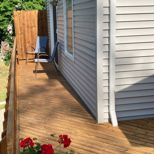 Exterior:  the other end of the backyard deck. The entrance to the deck from the master bedroom is where the chairs are at.