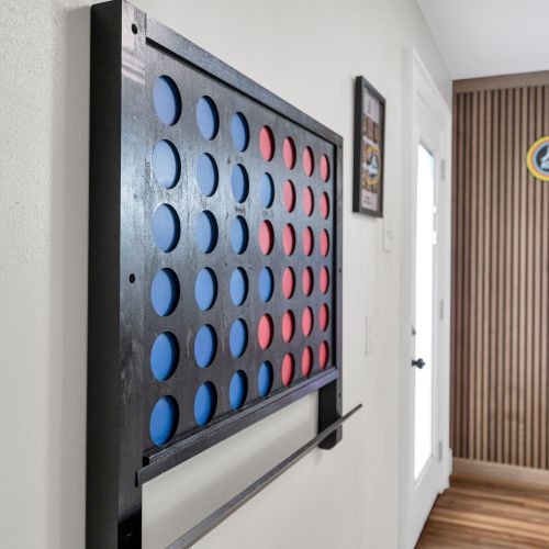 Oversized Connect Four on the wall — perfect for friendly competition any time.