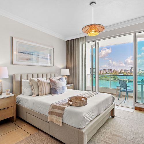 Dreamy bedroom with stunning ocean views and direct balcony access. Relax & unwind!