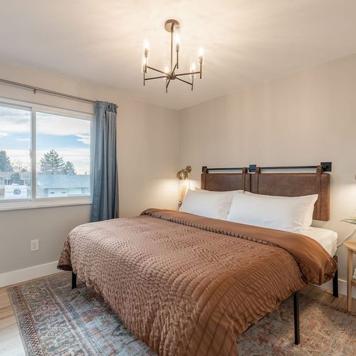 - sink into a king bed with crisp linens and a soft earthy comforter for restful sleep
- enjoy morning light and evening sunsets through the large picture window
- calming decor, soft lighting, and a vintage style rug set a serene, cozy vibe
