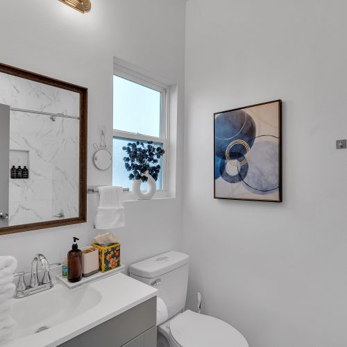 Contemporary bathroom with luxury essentials and stylish decor, ready to refresh and rejuvenate your stay.