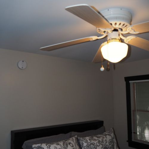 Bedroom #2 (main floor):  features a queen-size bed, ceiling fan, dresser, and closet.