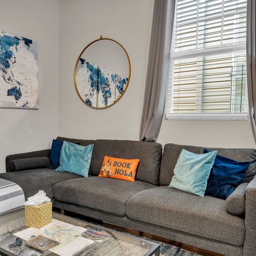 Relaxed living room sofa w/ colorful pillows & a laid-back local vibe.