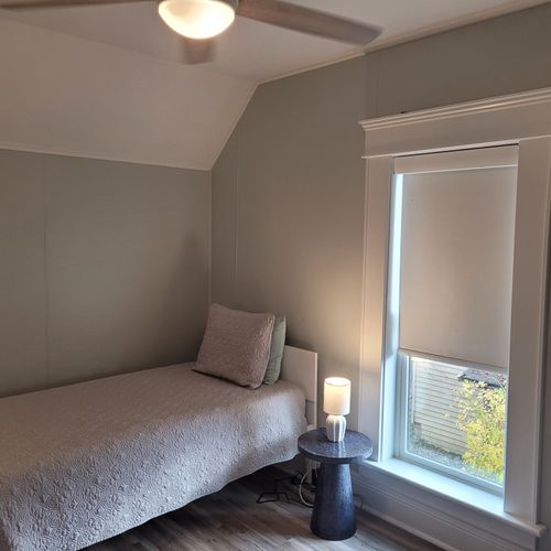 BEDROOM #4 (SECOND FLOOR):  Features 2 twin beds, window A/C unit (not shown), ceiling fan, nightstand, lamp, dresser, and a closet.