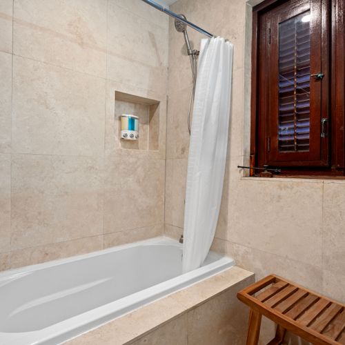 This tranquil bathroom, complete with a soothing bathtub, is the perfect place to relax and unwind after a long day.