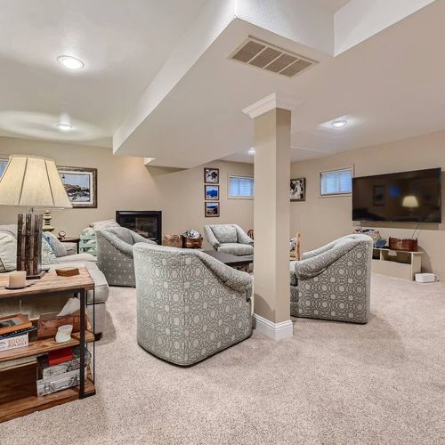 This room has both a large, 65" tv and a fireplace for ambience and warmth.