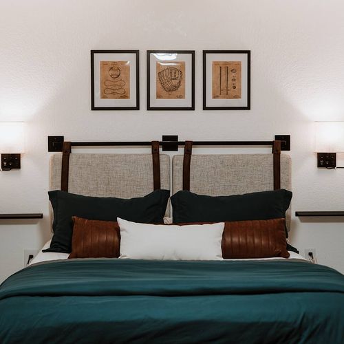 - sleep soundly with soft pillows, a rich color palette, and unique decor above the bed
- framed vintage sports art and warm bedside lighting set a relaxed, thoughtful tone
- perfect mix of sleek style and restful simplicity for a peaceful night’s st