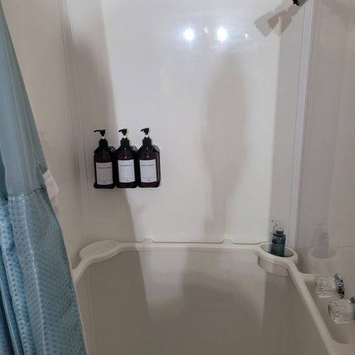 Bathroom:  very cute full bathroom with sink, vanity, mirror, shower, and toilet