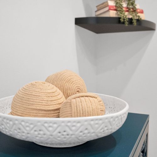 Decorative woven bowl adds warmth & texture to the space.
