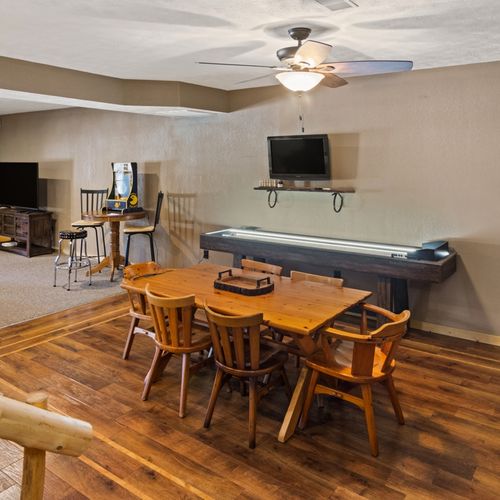 Lower level:  great family space in the lower level with dining table, wet bar, games, sofa, and television.