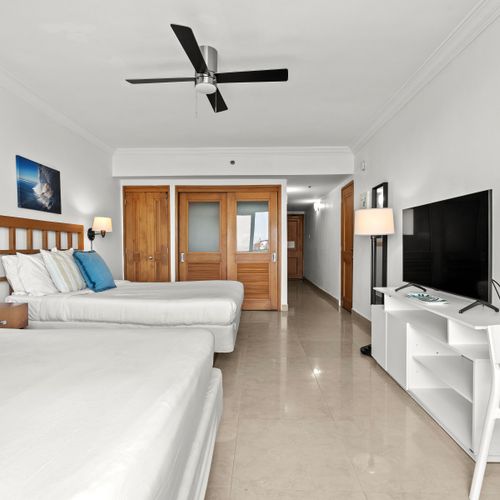 Your perfect retreat: well-appointed beds with artistic touches and direct access to outdoor views.