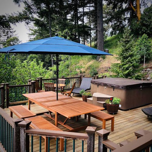 Outdoor dining for ten with sun loungers and umbrellas.