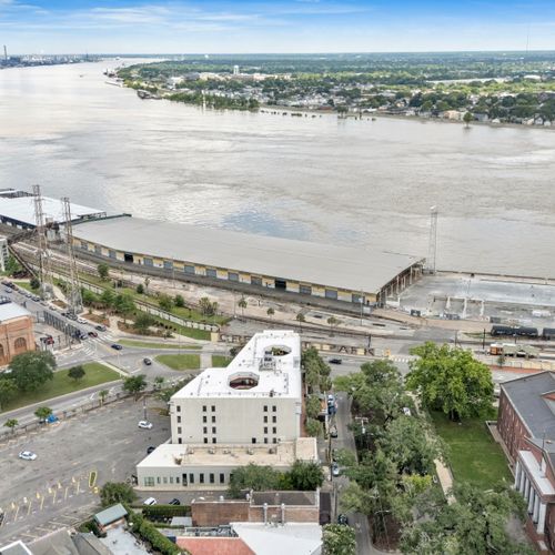 Aerial view of the riverfront with the wide, winding river in full view.