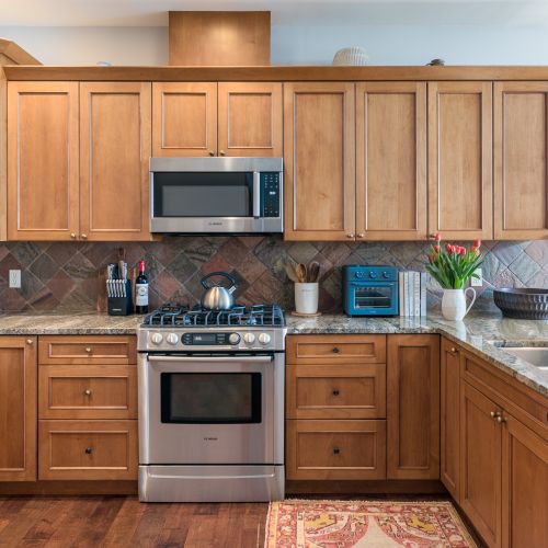 Spacious, fully equipped kitchen with granite countertops, perfect for cooking and gathering.