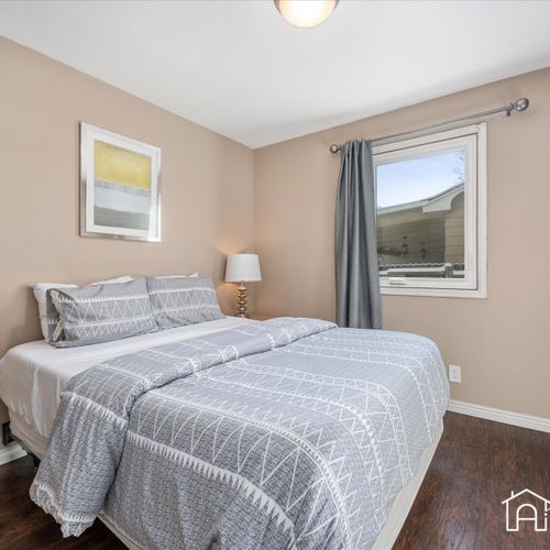 Get a restful night's sleep in the bright and cozy upstairs bedroom, featuring a queen size bed and a serene ambiance.