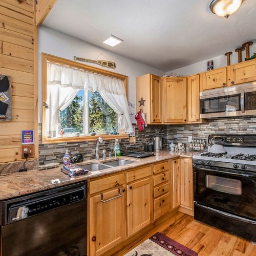 - start your mornings with sunlight pouring in through the large kitchen window with forest views
