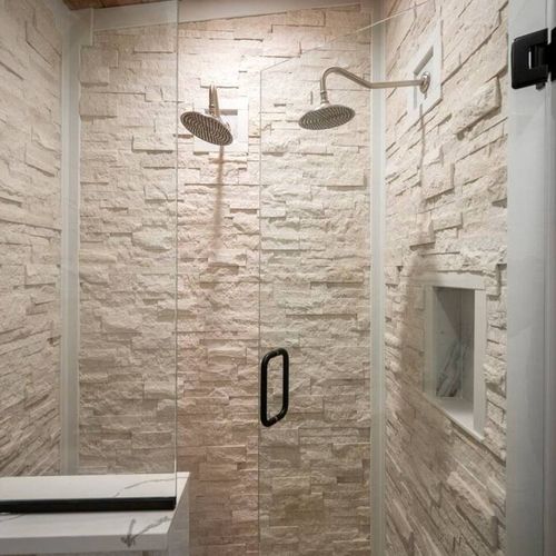Multiple shower heads in the stone walk-in shower.
