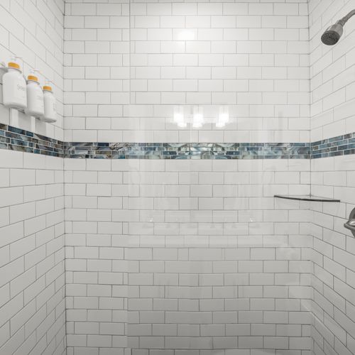 Refresh in a spacious walk-in shower stocked with essentials.