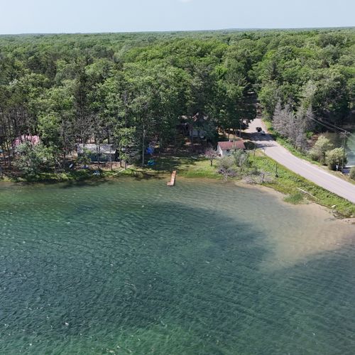 EXTERIOR:  Another aerial photo showing the dock with the property in the background