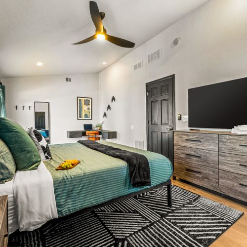 A comfy bed and in-room tv make this master the perfect place to chill after a full day.