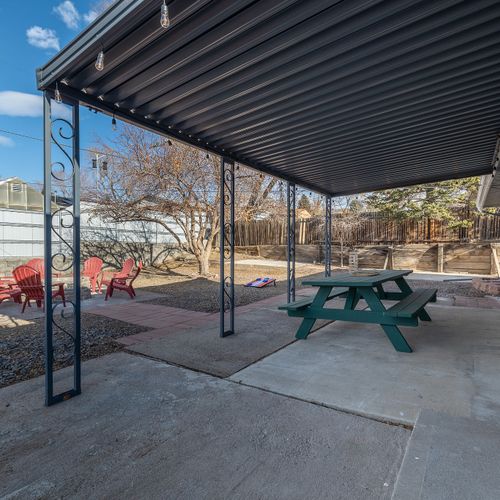 The outdoor picnic table, adirondack chairs, outdoor lighting, and mountain views are perfect for enjoying the fresh air.