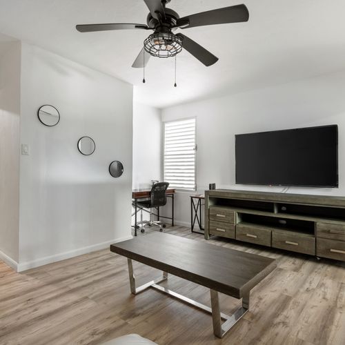 Cozy living room with a large flat-screen TV for entertainment.