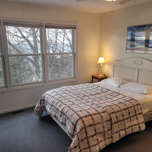Bedroom #2 (upper level):  features a queen-size bed, great views of lake michigan, dresser, mirror, closet, desk, and private en suite full bathroom!