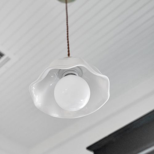 Clean, sculptural ceiling light adding a subtle design touch overhead.