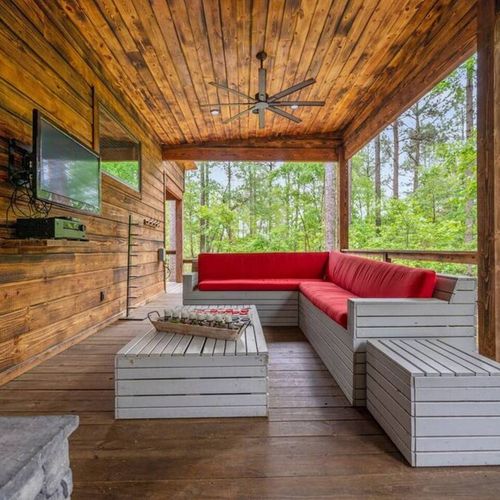 Outdoor sectionals are placed around a flat screen for ultimate entertainment.
