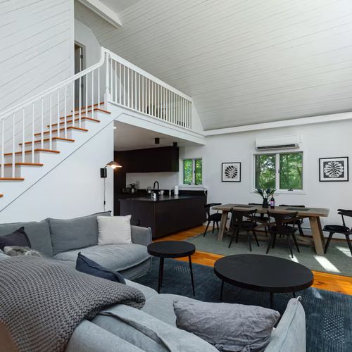 View of the kitchen, dining, and living area. Stairs lead to upstairs master bedroom
