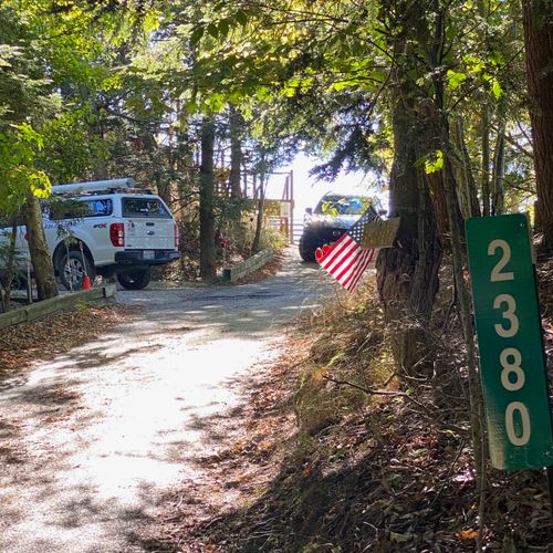 EXTERIOR:  Parking pad (on the left) along with TEMPORARY parking place for loading and unloading (on the right) at the top of the drive near the steps.