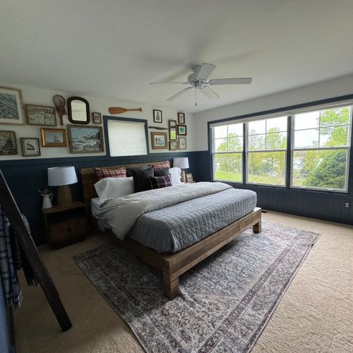 Bedroom #1 (main floor):  features a king-size bed, private en-suite bathroom, ceiling fan, shelves, and great views of the backyard, long lake, and sleeping bear dunes.
