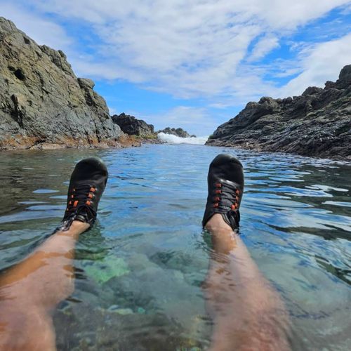Experience a refreshing dip in a secluded natural pool, embraced by dramatic rock formations and the open sky. Adventure awaits