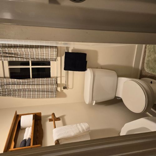 Bathroom:  there is a full bathroom with a shower, sink, vanity, mirror, and toilet.