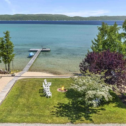 PRIMARY BEDROOM (UPPER LEVEL):  Looking out over the gorgeous private backyard and Crystal Lake from the private balcony