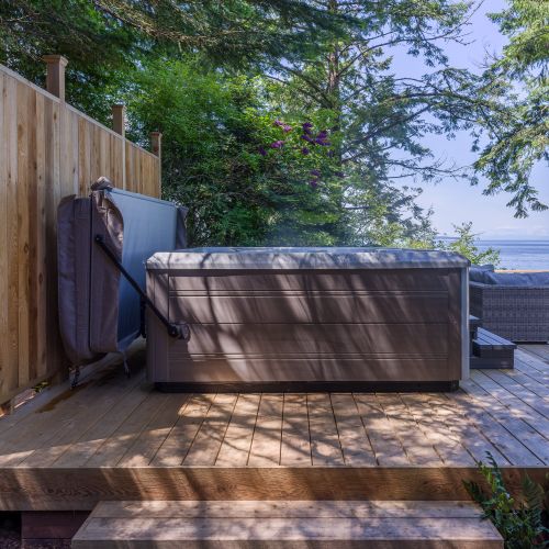 Six-person hot tub with incredible views and a privacy fence.  Not pictured, but a large dog kennel is tucked on the side of the house with night time access through a dog door!