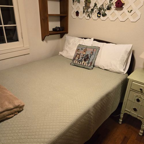 Bedroom #1:  features a full-size bed, nightstand, lamp, and dresser.