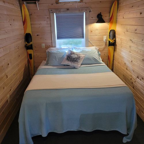 Living area:  the queen-size bed, with the home's a/c unit just above the bed.