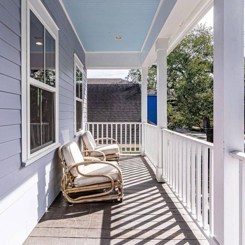 Covered balcony w/ seating — the perfect perch for a quiet morning coffee.