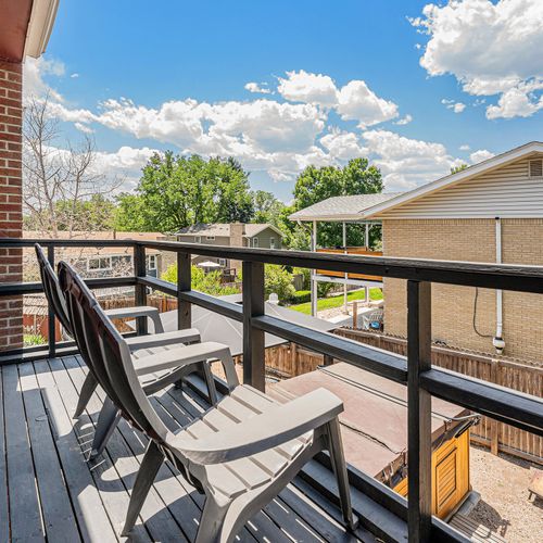 The balcony off the master suite offers a private retreat with seating for two, providing a tranquil space to enjoy the outdoors in comfort and intimacy.