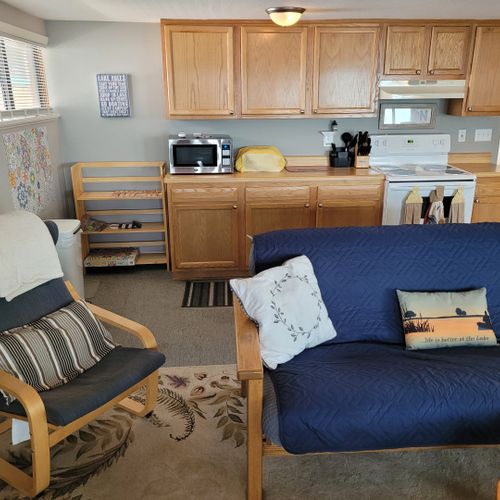 Living room:  cozy living room with a futon, chair, streaming television, and a great view of van etten lake!