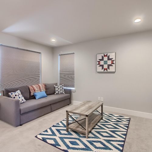 - enjoy extra space in your suite with this comfy sitting area and soft patterned rug
- ideal for morning coffee, quiet reading, or late night streaming
- neutral colors and soft lighting create a calm and welcoming atmosphere