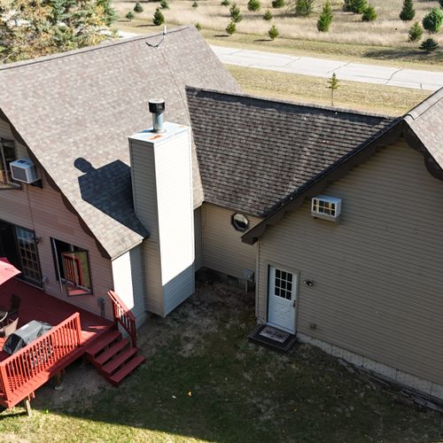 EXTERIOR:  Another aerial view of the house and the backyard deck